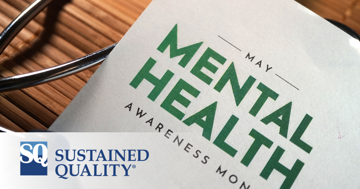 closeup of paper on desk that reads May Mental Health Awareness Month